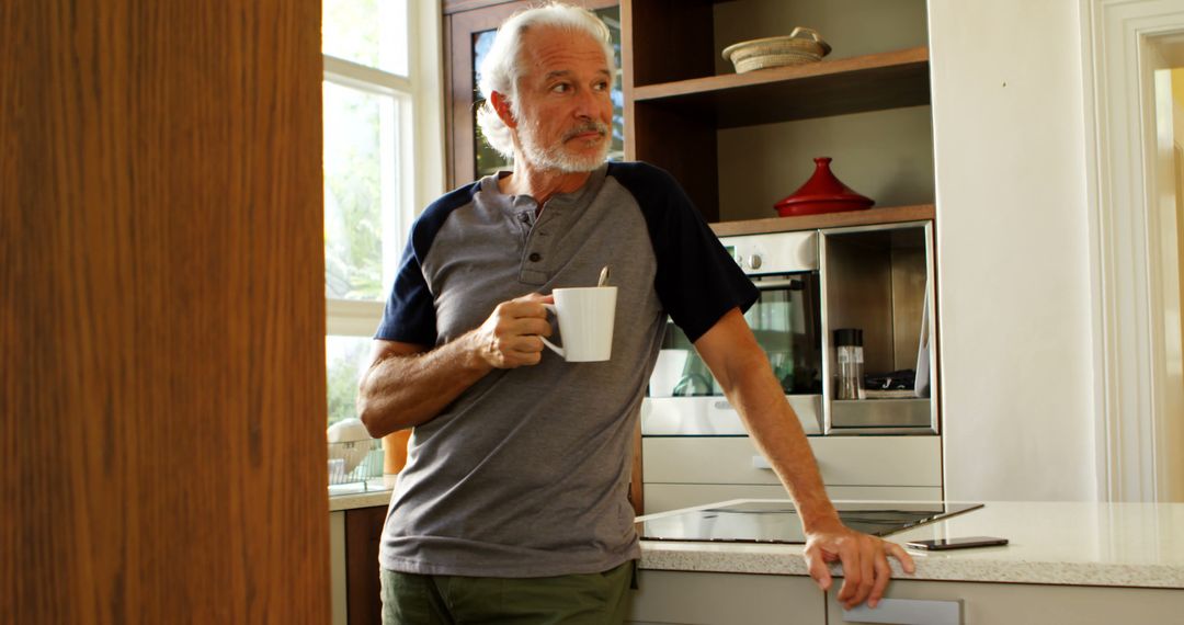 Senior Man Enjoying Coffee in Modern Kitchen - Free Images, Stock Photos and Pictures on Pikwizard.com