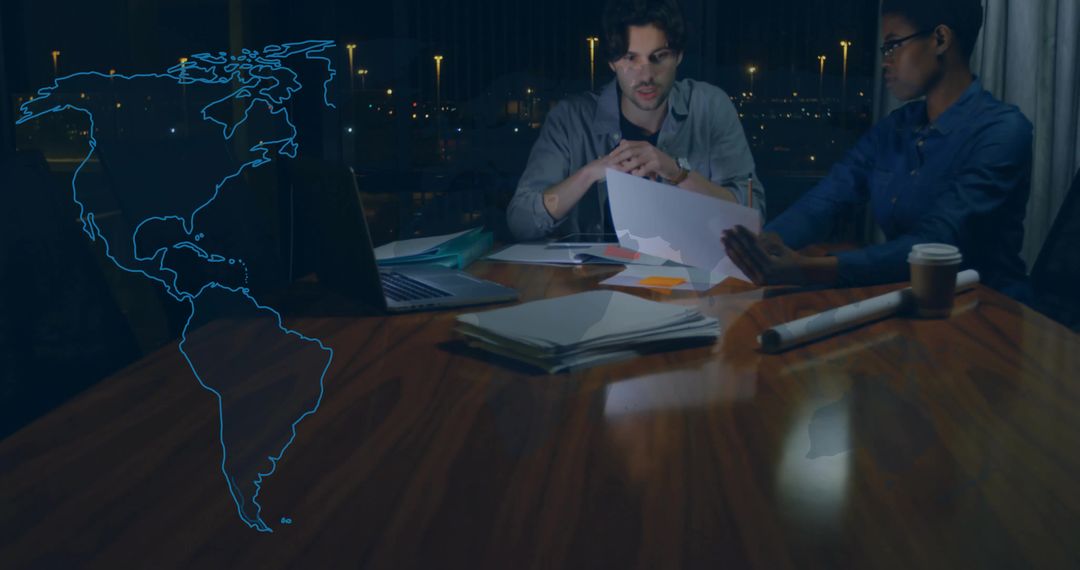 Business Professionals Innovating with Hologram Technology at Night