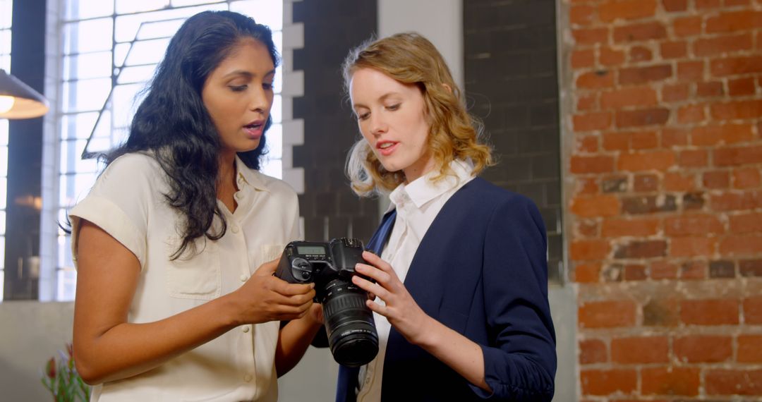 Female Photographers Reviewing Camera Settings Together - Free Images, Stock Photos and Pictures on Pikwizard.com