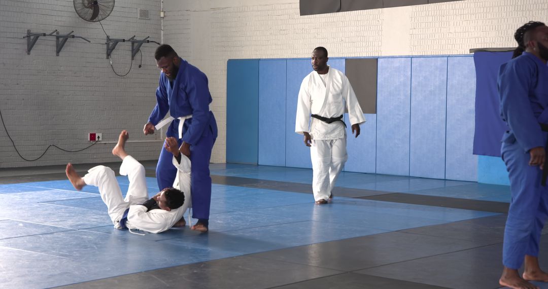 Judo Training Practice in Gym with Men Throwing on Tatami Mats