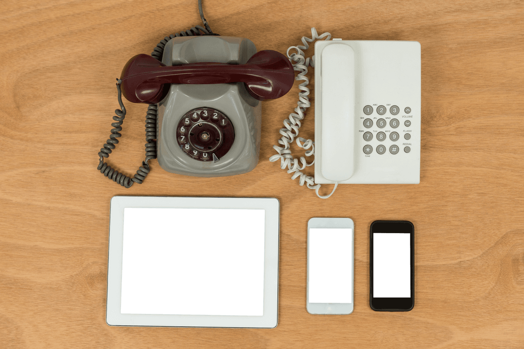 Contrast of Vintage Rotary Phone and Modern Devices on Transparent Table