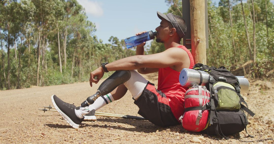 Man with Prosthetic Leg Taking Break from Hiking and Drinking Water - Free Images, Stock Photos and Pictures on Pikwizard.com