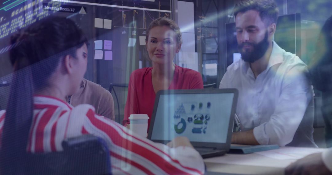 Team Collaborating in Modern Office with Digital Analytics on Laptop