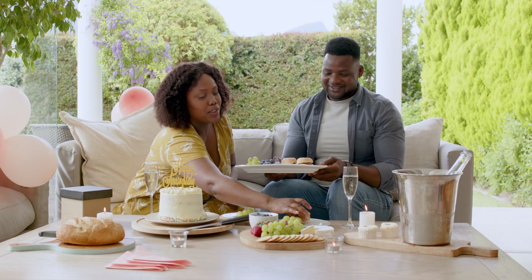 African American Couple Celebrating Birthday with Cake Outdoors