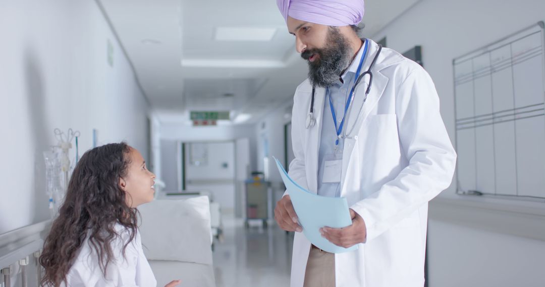 Compassionate Doctor Consults with Young Patient in Hospital - Free Images, Stock Photos and Pictures on Pikwizard.com