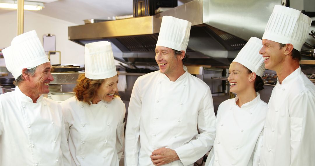 Chefs Laughing Together in Professional Kitchen - Free Images, Stock Photos and Pictures on Pikwizard.com