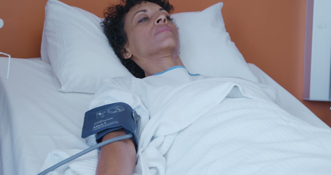 Woman Lying in Hospital Bed with Blood Pressure Monitor - Free Images, Stock Photos and Pictures on Pikwizard.com