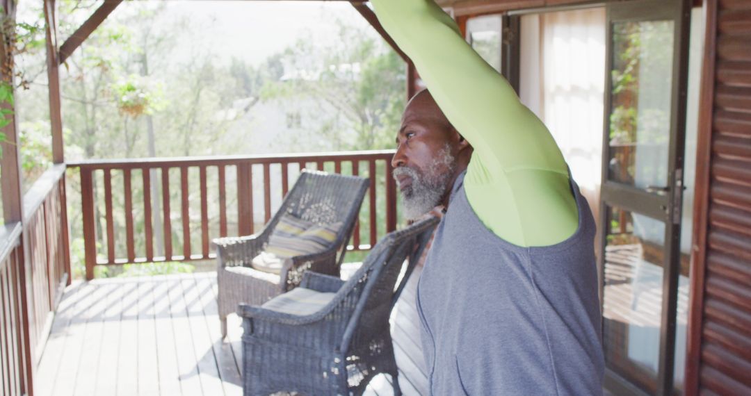 Senior Man Stretching on Balcony During Home Workout - Free Images, Stock Photos and Pictures on Pikwizard.com