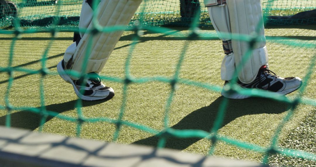 Cricket Player Practicing in Net, Focus on Legs and Equipment - Free Images, Stock Photos and Pictures on Pikwizard.com