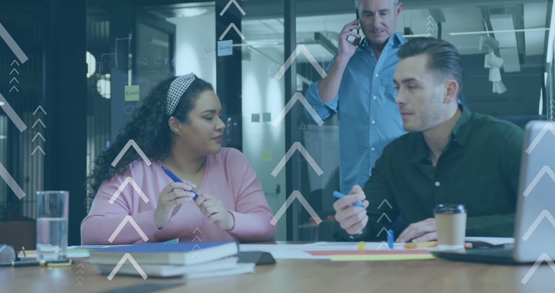 Diverse Team Collaborating in Office with Data Graphics Overlay