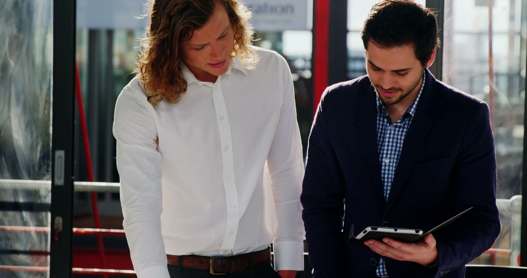 Business Executives Discussing Blueprint Ideas in Modern Office