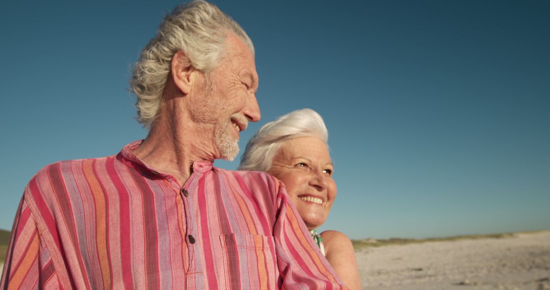 Happy Elderly Couple Enjoying Beach Time Together - Free Images, Stock Photos and Pictures on Pikwizard.com