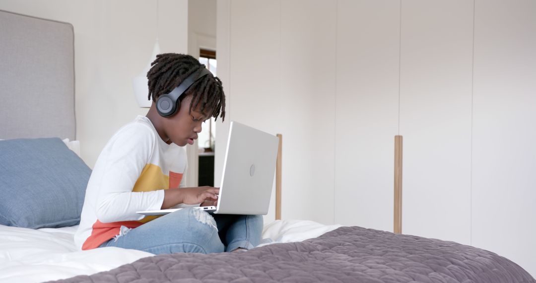 Young Boy Using Laptop with Headphones for Online Learning at Home - Free Images, Stock Photos and Pictures on Pikwizard.com