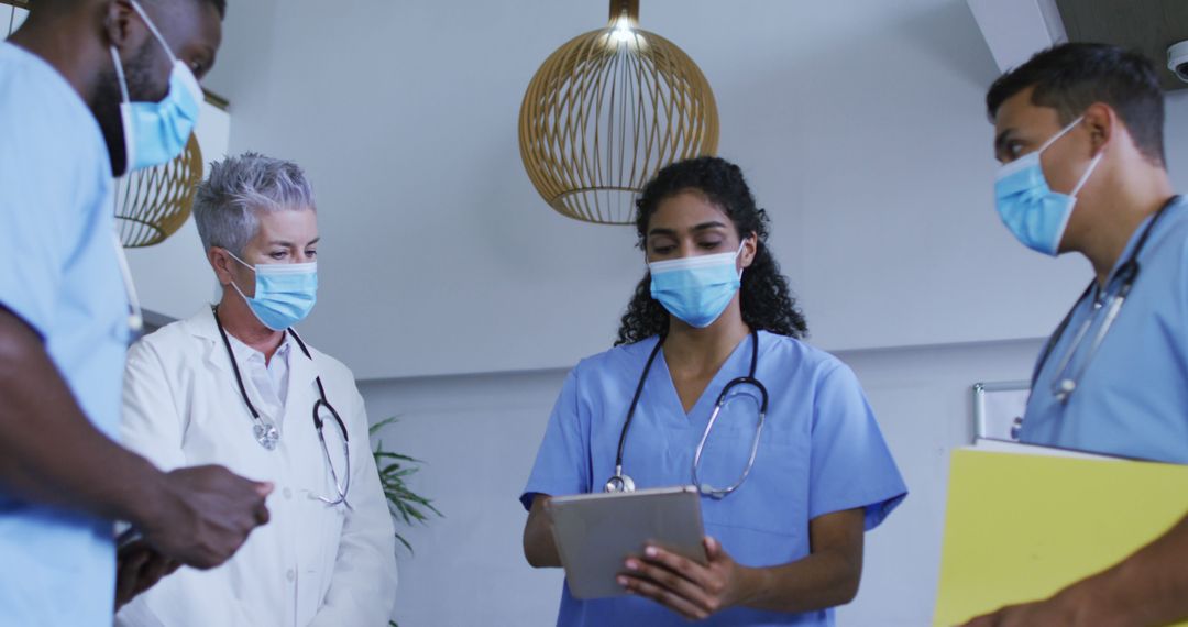 Group of Medical Professionals Discussing Patient Reports - Free Images, Stock Photos and Pictures on Pikwizard.com