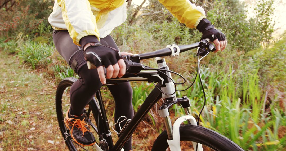 Cyclist in Yellow Jacket Riding A Bicycle on Woodland Path - Free Images, Stock Photos and Pictures on Pikwizard.com