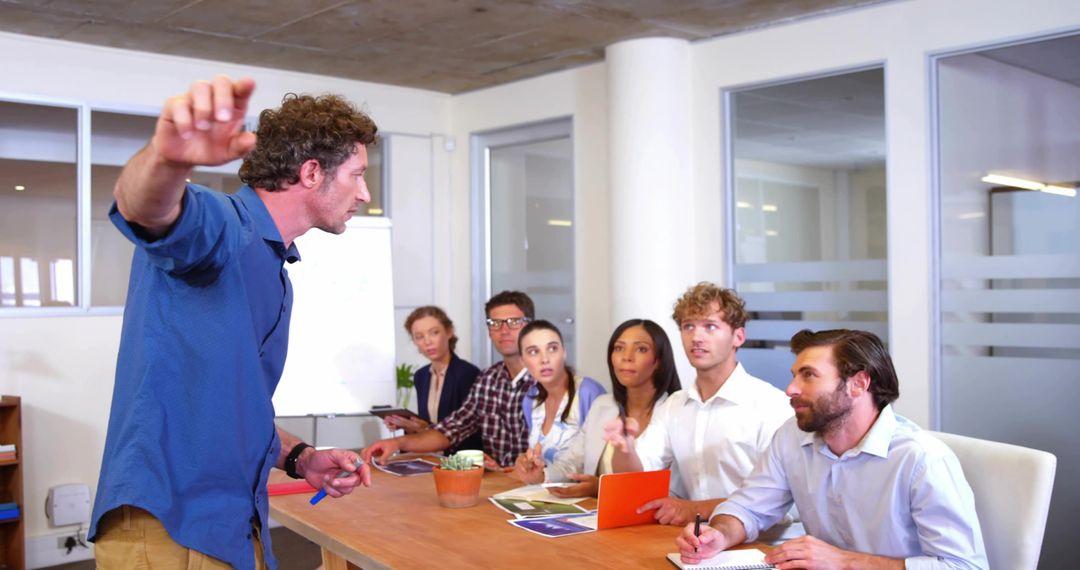 Leading Team Presentation in Modern Boardroom With Gesturing Presenter and Engaged Group