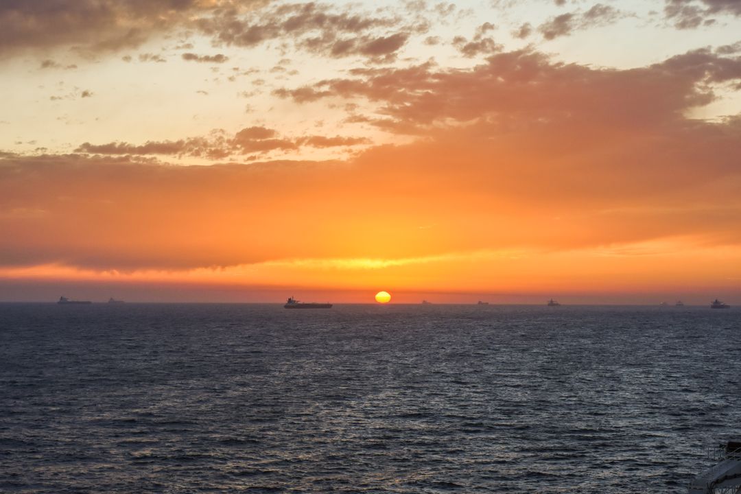 Stunning Sunset Over Ocean with Distant Ships - Free Images, Stock Photos and Pictures on Pikwizard.com