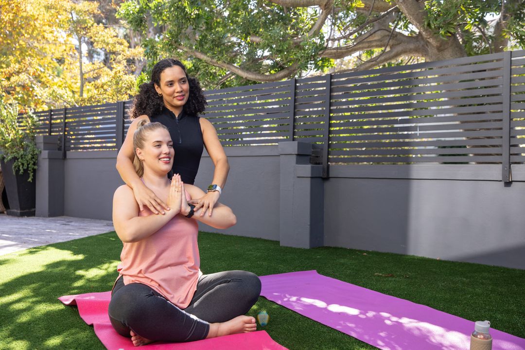 Female Instructor Guiding Student in Backyard Meditation Session