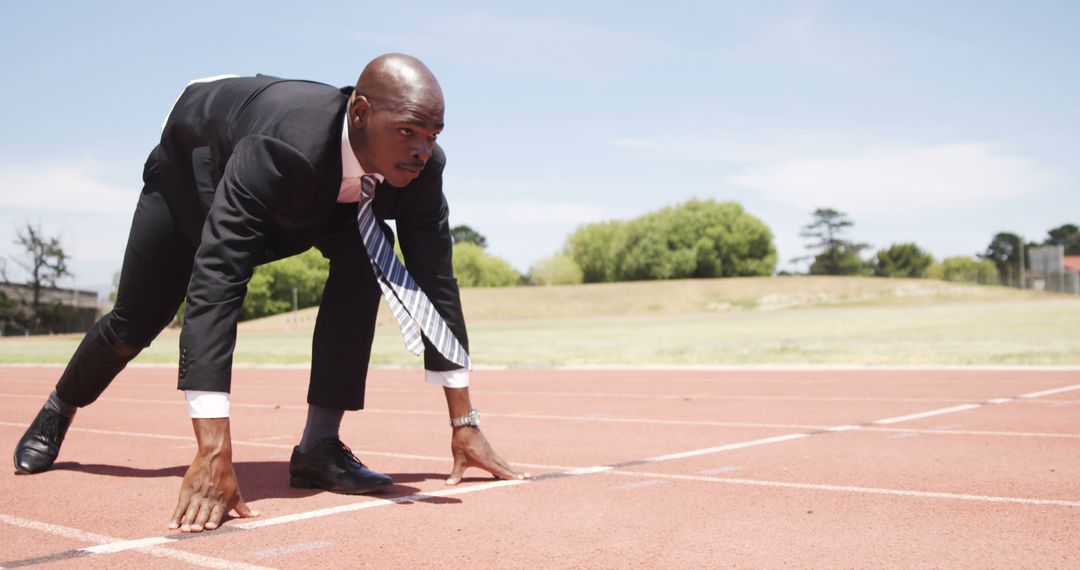 Businessman in Suit Ready to Sprint on Track - Free Images, Stock Photos and Pictures on Pikwizard.com