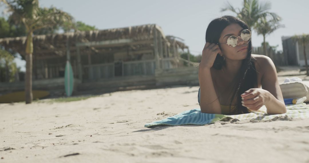 Woman Relaxing on Beach Towel on Sandy Shore - Free Images, Stock Photos and Pictures on Pikwizard.com