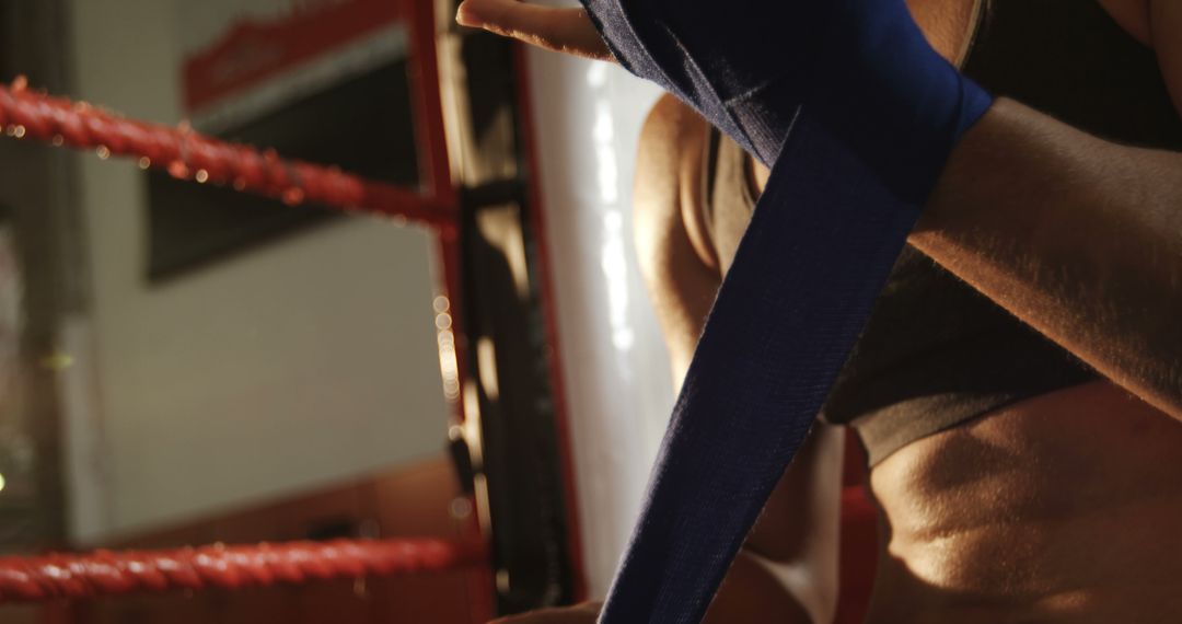 Female Boxer Wrapping Hands with Blue Bandages Before Training - Free Images, Stock Photos and Pictures on Pikwizard.com