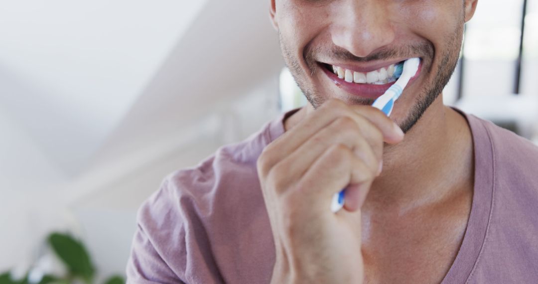 Smiling Man Brushing Teeth, Maintaining Oral Hygiene - Free Images, Stock Photos and Pictures on Pikwizard.com