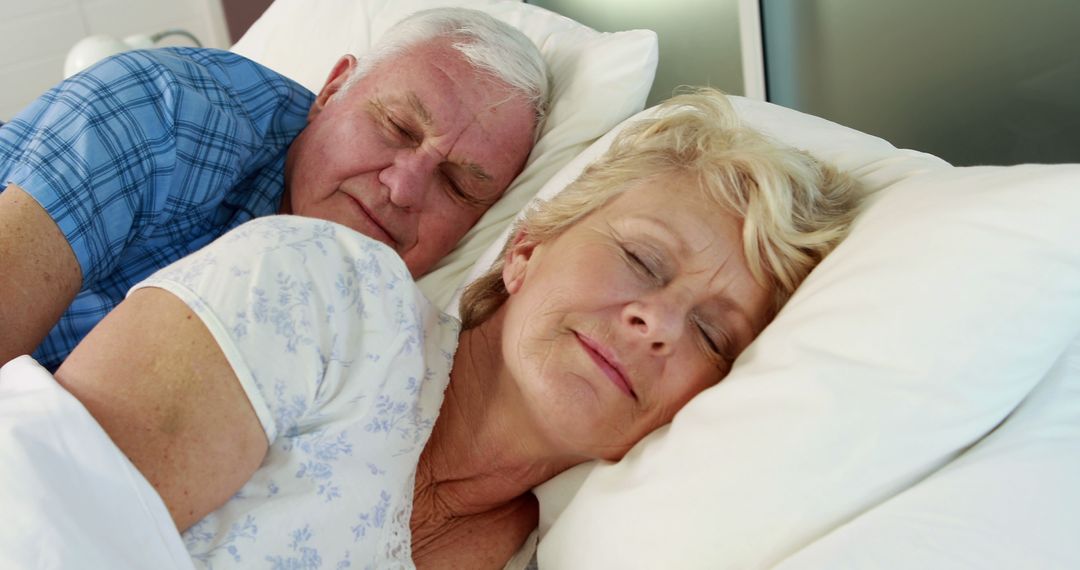 Senior couple sleeping in bed together - Free Images, Stock Photos and Pictures on Pikwizard.com