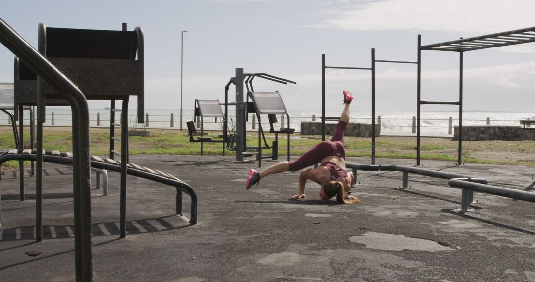 Woman Practicing Gymnastics in Outdoor Gym by Ocean - Free Images, Stock Photos and Pictures on Pikwizard.com