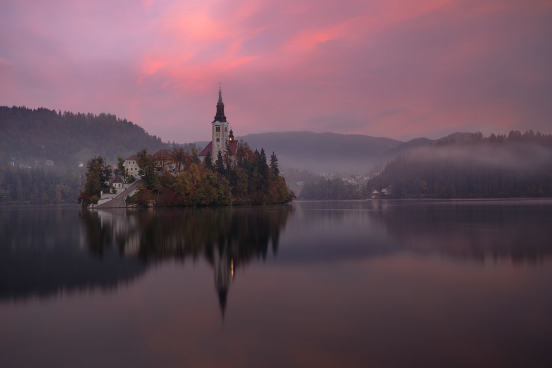Church on Lake Bled at Sunrise with Pink Sky - Free Images, Stock Photos and Pictures on Pikwizard.com