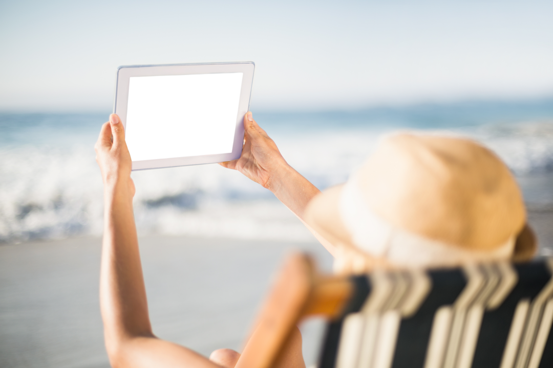 Transparent Screen Tablet Used by Woman on Beach with Sun Hat at Ocean - Download Free Stock Images Pikwizard.com