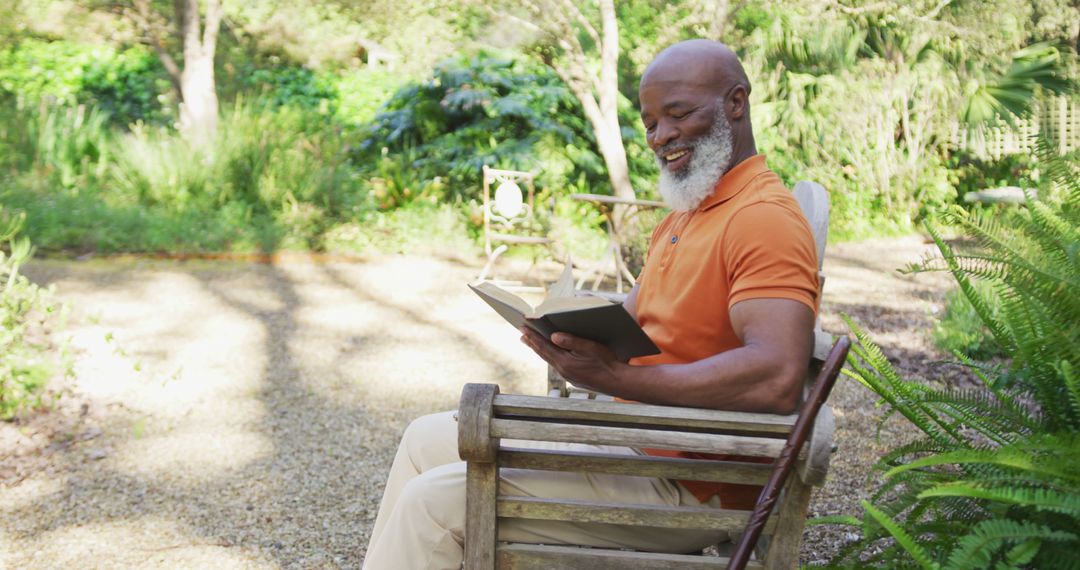 Senior Man Reading Book on Wooden Bench in Garden - Free Images, Stock Photos and Pictures on Pikwizard.com