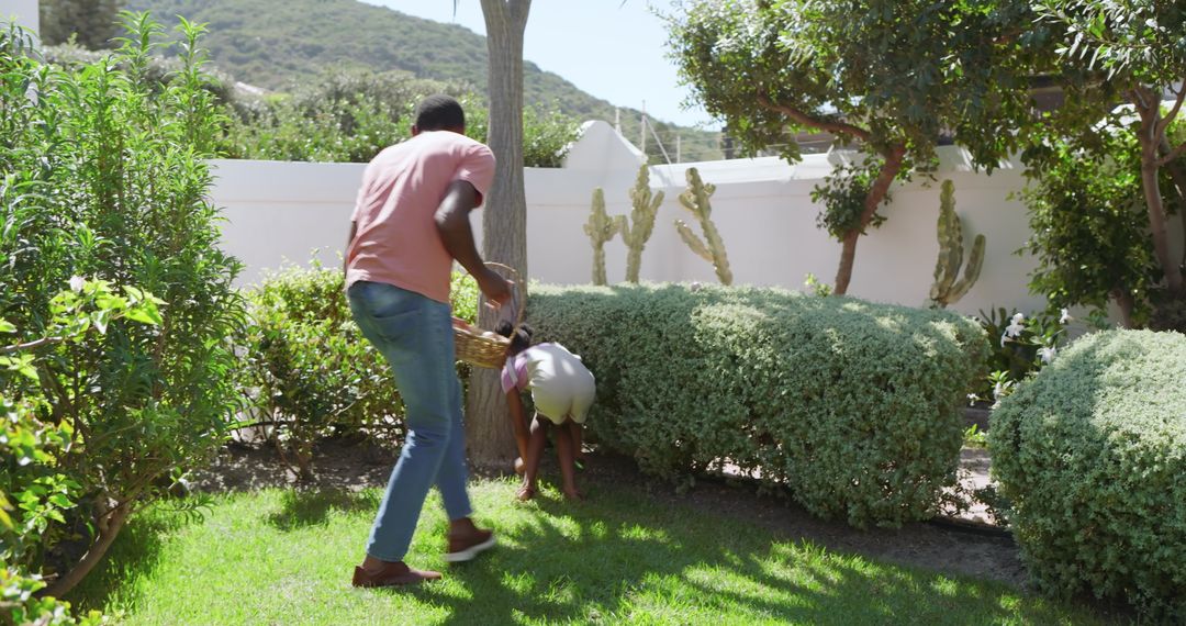 Father and Daughter Exploring Garden with Basket in Hand