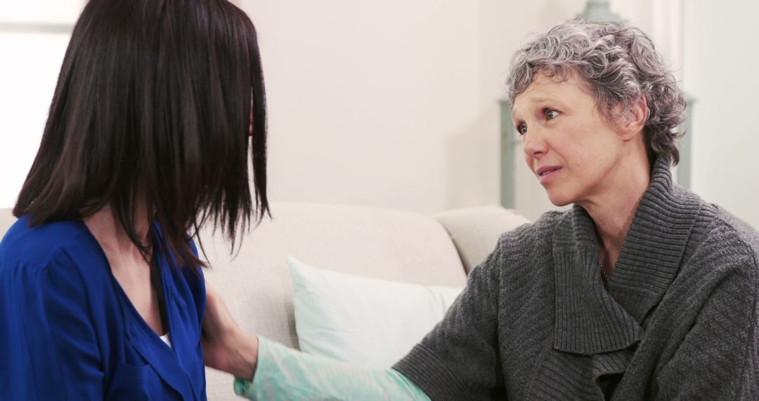 Elderly Woman Comforting Younger Woman during Difficult Conversation - Free Images, Stock Photos and Pictures on Pikwizard.com