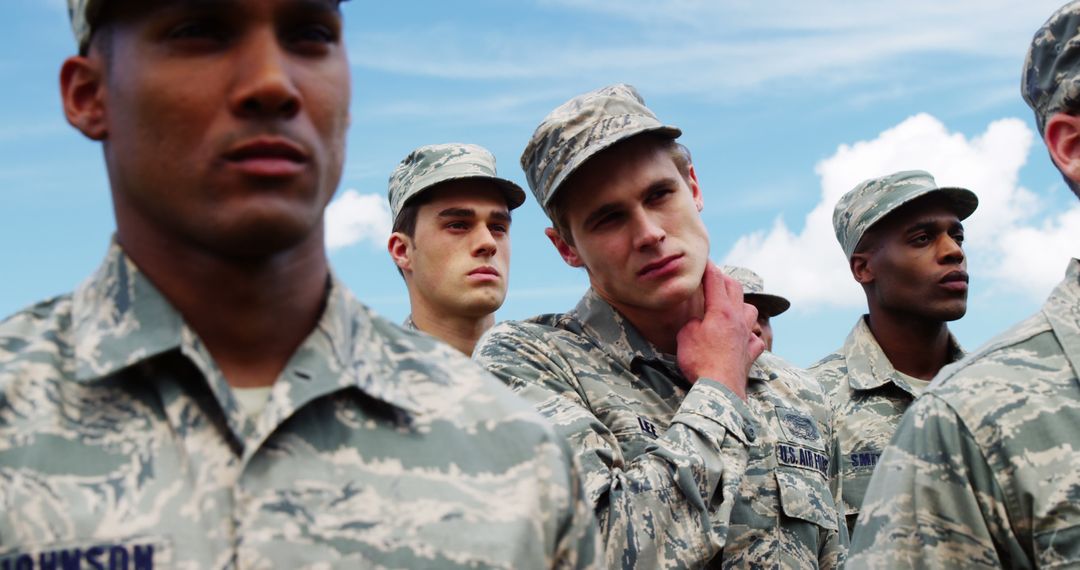 Diverse Young Military Personnel Standing with Serious Expressions