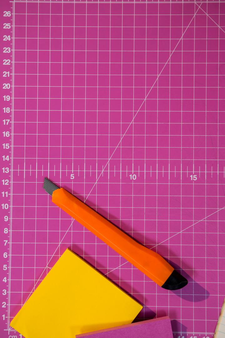 Sticky notes and cutter on graph - Free Images, Stock Photos and Pictures on Pikwizard.com