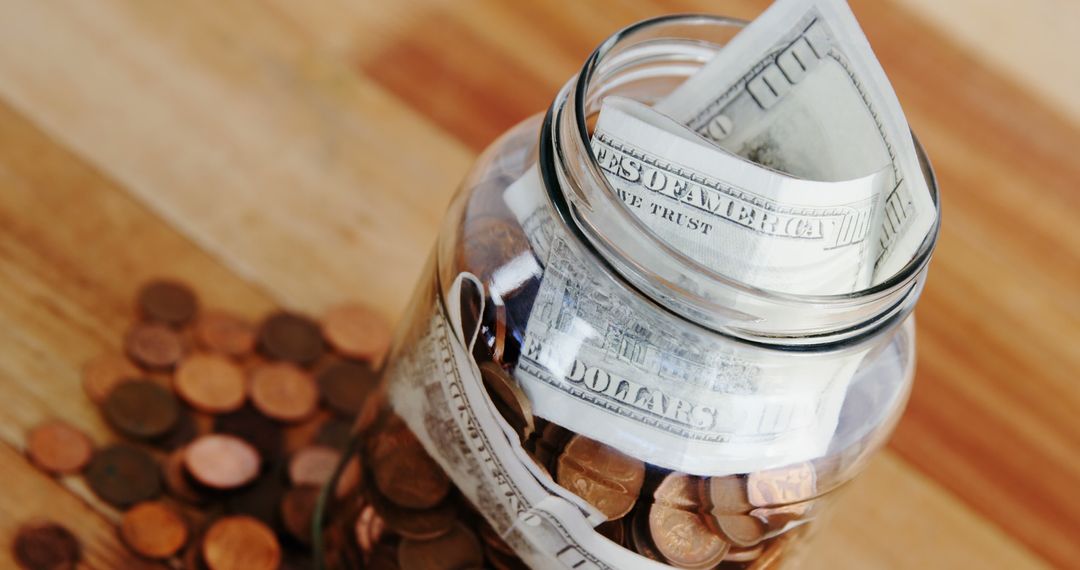 Jar Filled with Dollar Bills and Coins on Wooden Table - Free Images, Stock Photos and Pictures on Pikwizard.com