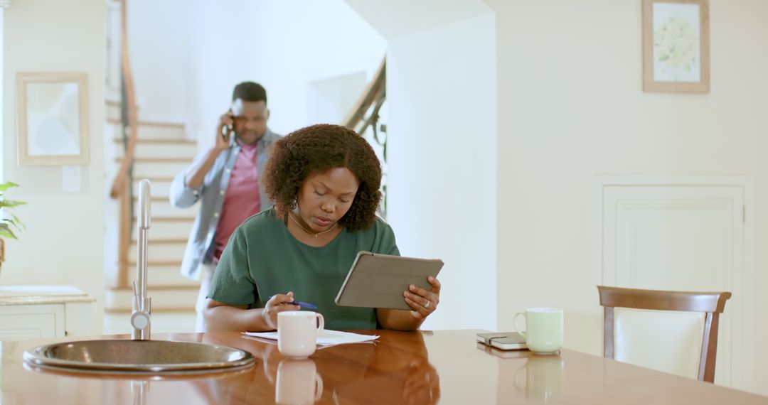 Couple Reviewing Documents with Tablet in Home Setting