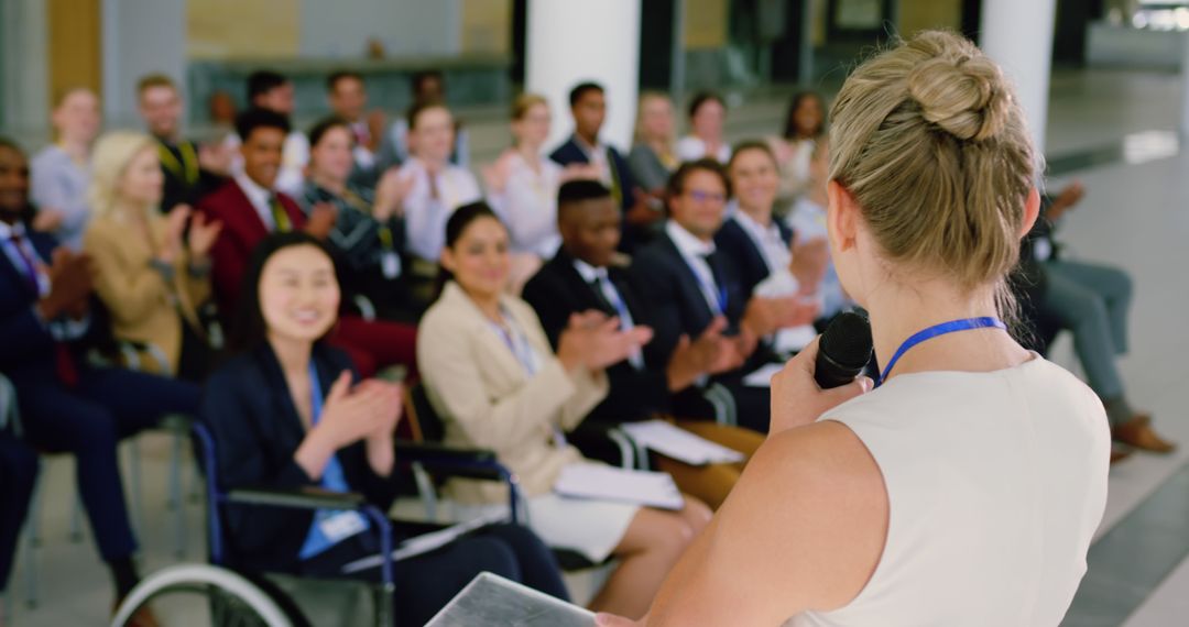 Businesswoman Speaking in Conference Room to Applauding Audience - Free Images, Stock Photos and Pictures on Pikwizard.com