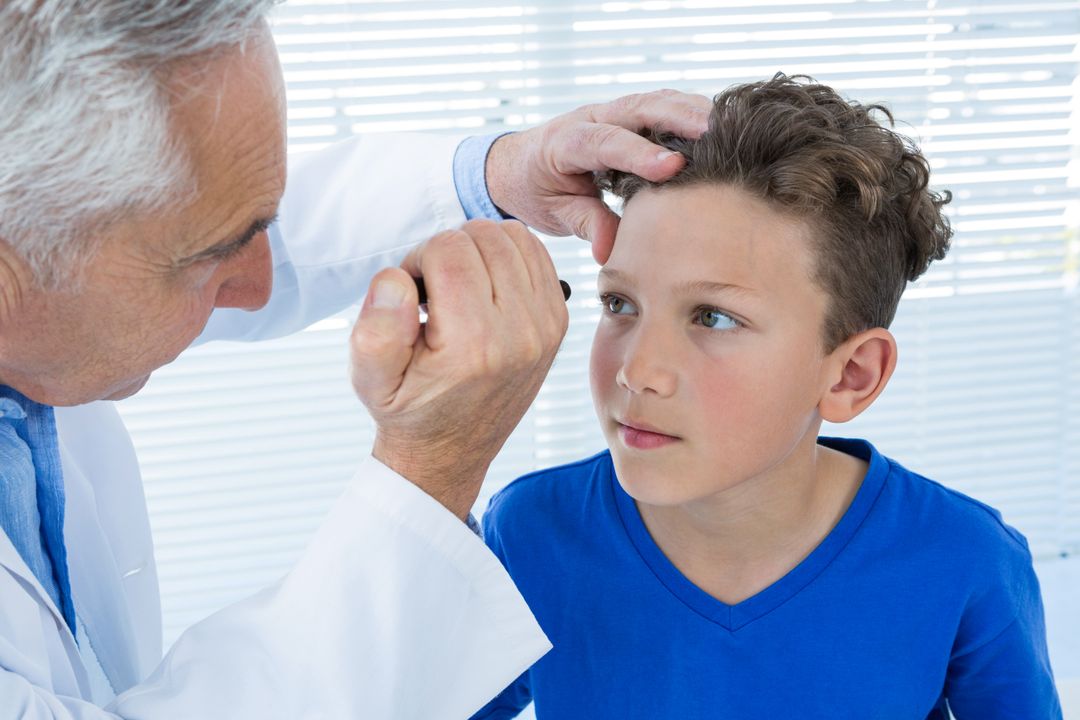 Doctor Examining Boy's Eye in Clinic - Free Images, Stock Photos and Pictures on Pikwizard.com