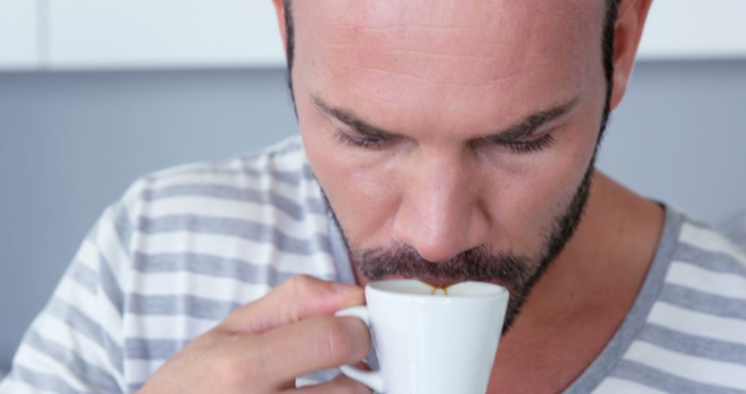 Man Enjoying Hot Beverage from White Cup - Free Images, Stock Photos and Pictures on Pikwizard.com