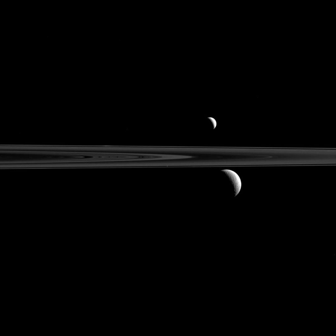 Saturn Moons Enceladus and Rhea with Rings Captured by Cassini Spacecraft
