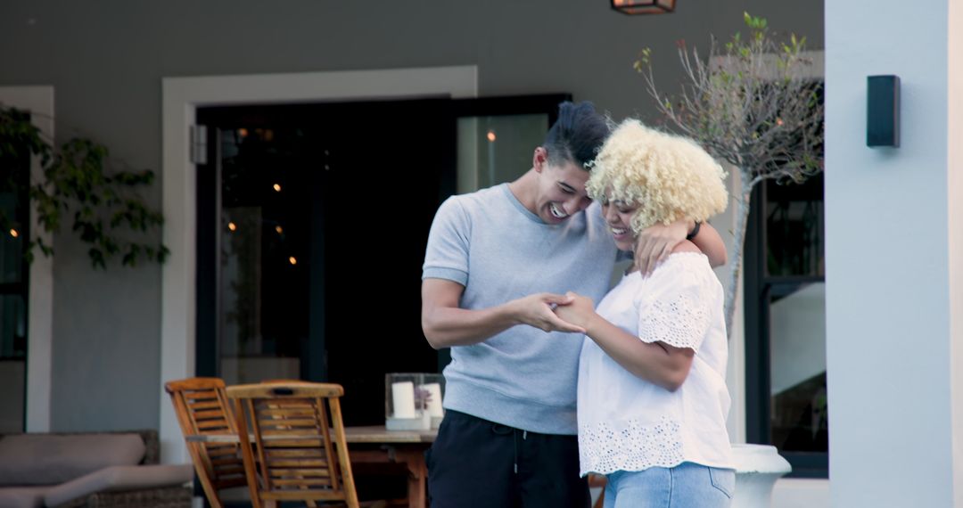 Man Proposing to Smiling Partner on Outside Terrace