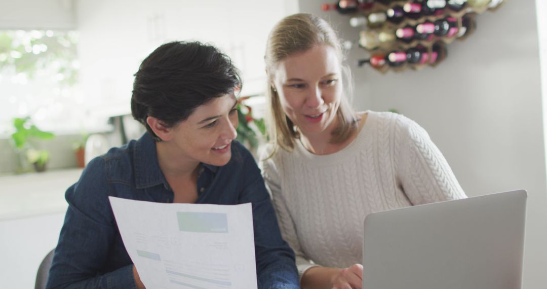 Caucasian lesbian couple calculating finances together using laptop at home - Free Images, Stock Photos and Pictures on Pikwizard.com