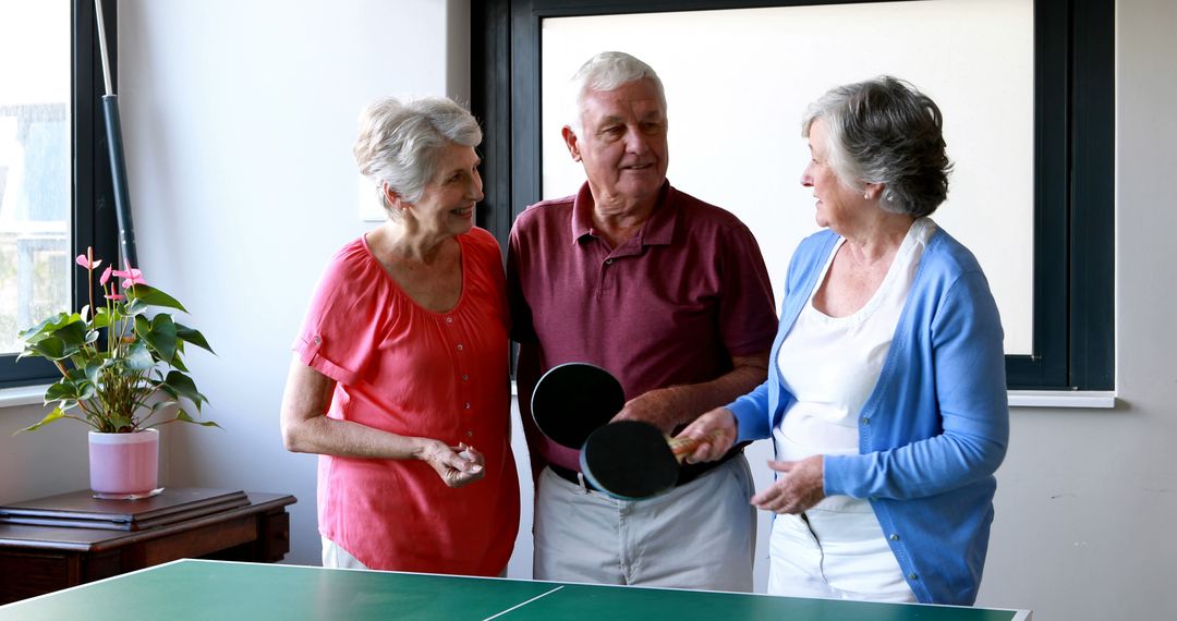 Smiling Senior Citizens Enjoying Ping Pong Indoors - Free Images, Stock Photos and Pictures on Pikwizard.com