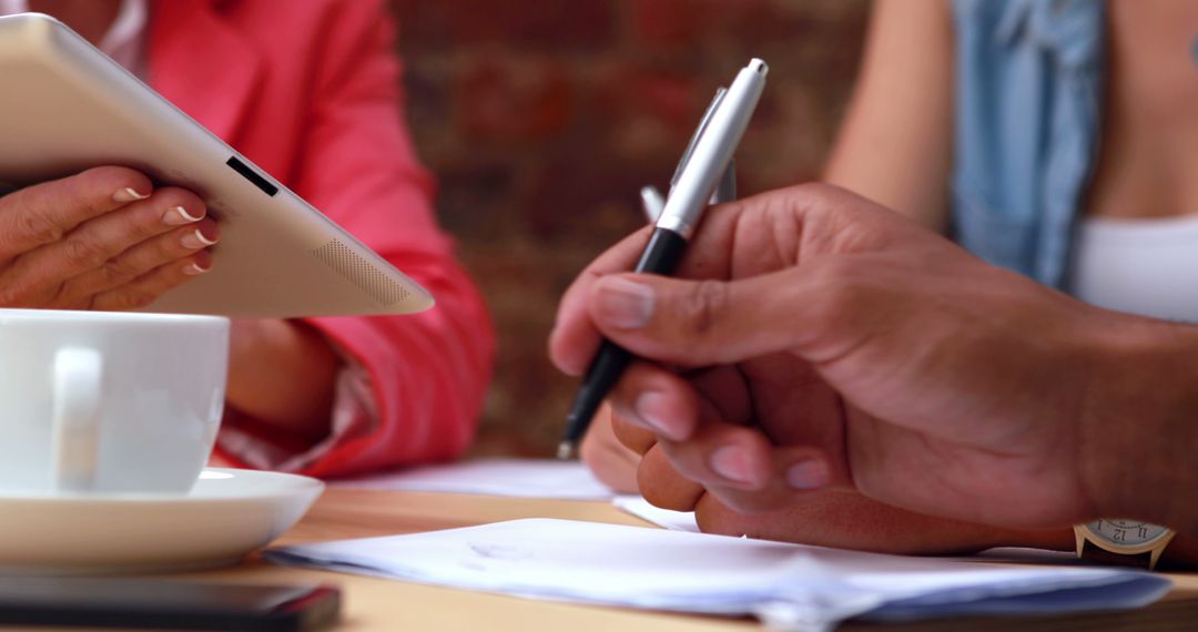 Casual Business Team Collaborating with Tablet