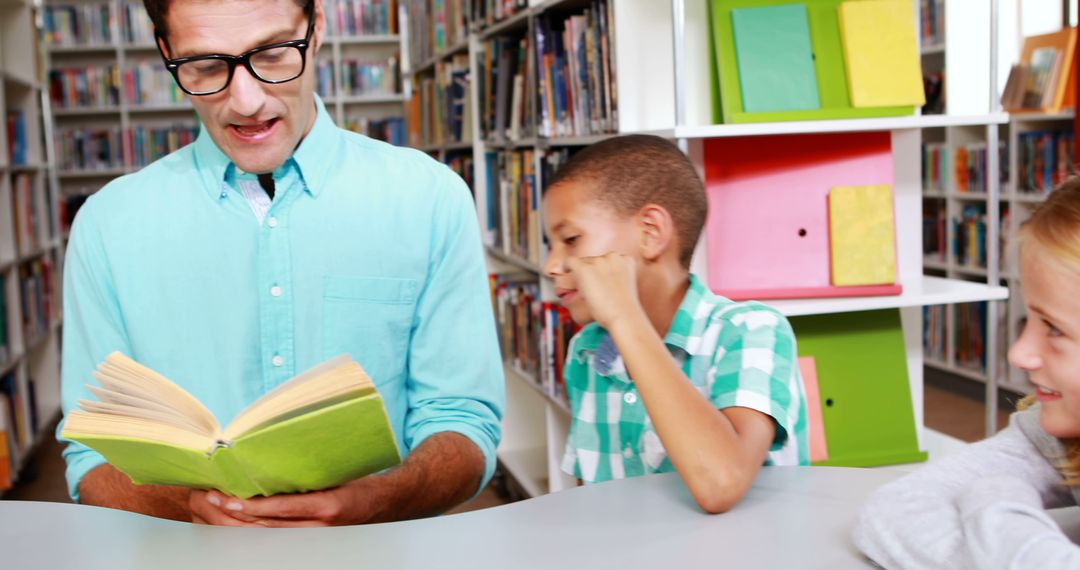 Male Teacher Reading to Children in Library - Free Images, Stock Photos and Pictures on Pikwizard.com