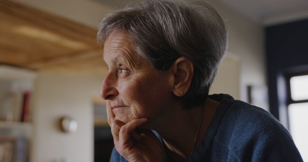 Elderly Woman Reflecting in Thoughtful Pose Indoors - Free Images, Stock Photos and Pictures on Pikwizard.com