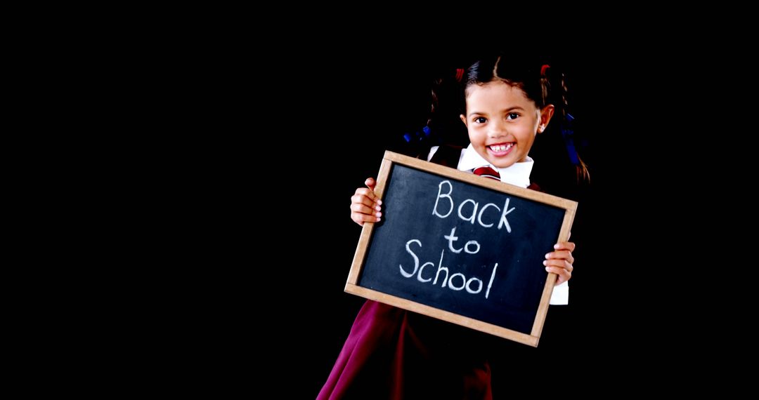 Cheerful Student Holds Back to School Sign with Enthusiasm