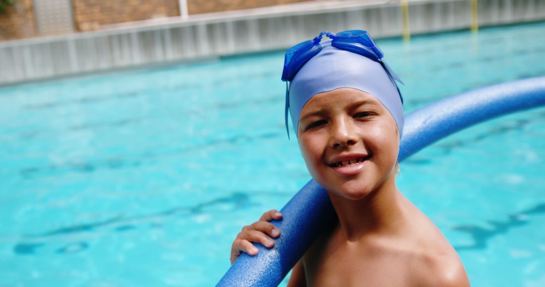 Smiling Child Swimmer Holding Pool Noodle in Blue Water - Free Images, Stock Photos and Pictures on Pikwizard.com