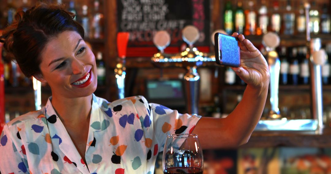 Woman Taking Selfie in Pub with Glass of Wine